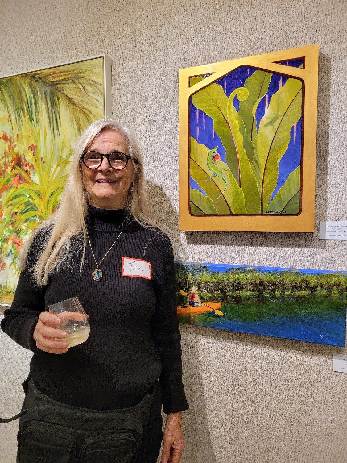 Teri Tompkins, an artist at St. Augustine Art Association, attends a recent event in front of her artwork, “Love in the Afternoon,” acrylic on birch panel.